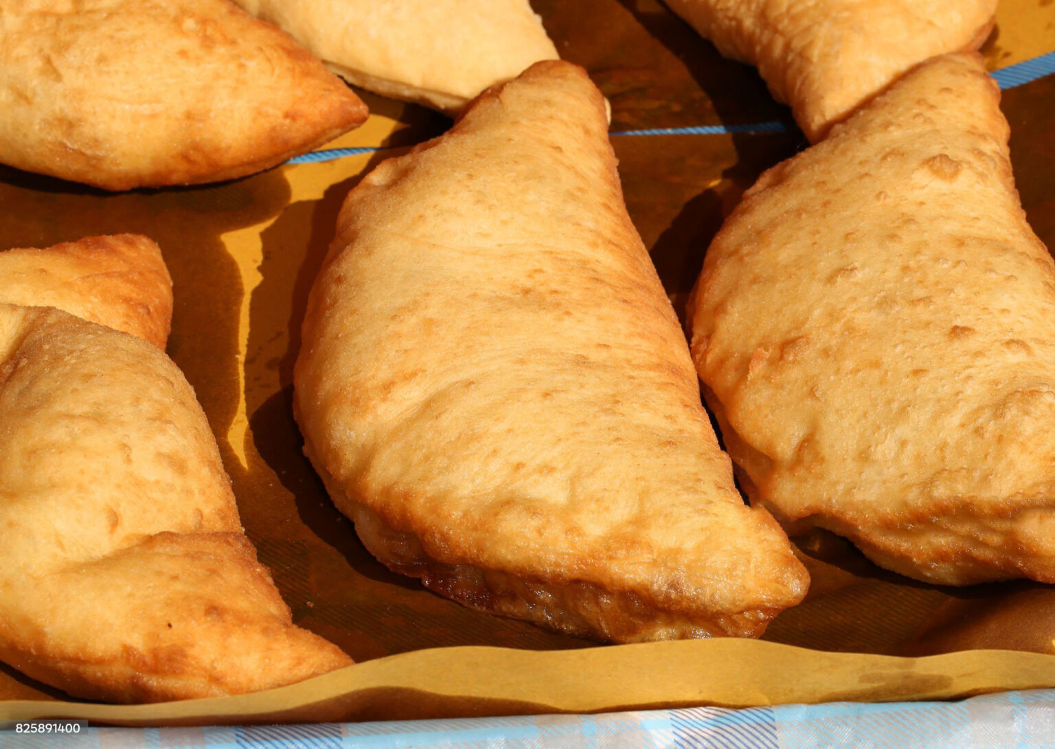 Deatil of italian stuffed fried bread called Panzerotti or Pizza Puff with tomato and cheese